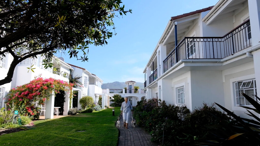 woman walking dogs on the pet-friendly retirement estate